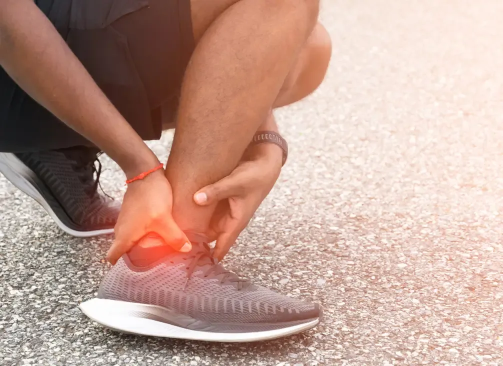 A podiatrist assessing the Achilles tendon at the back of a patient's ankle