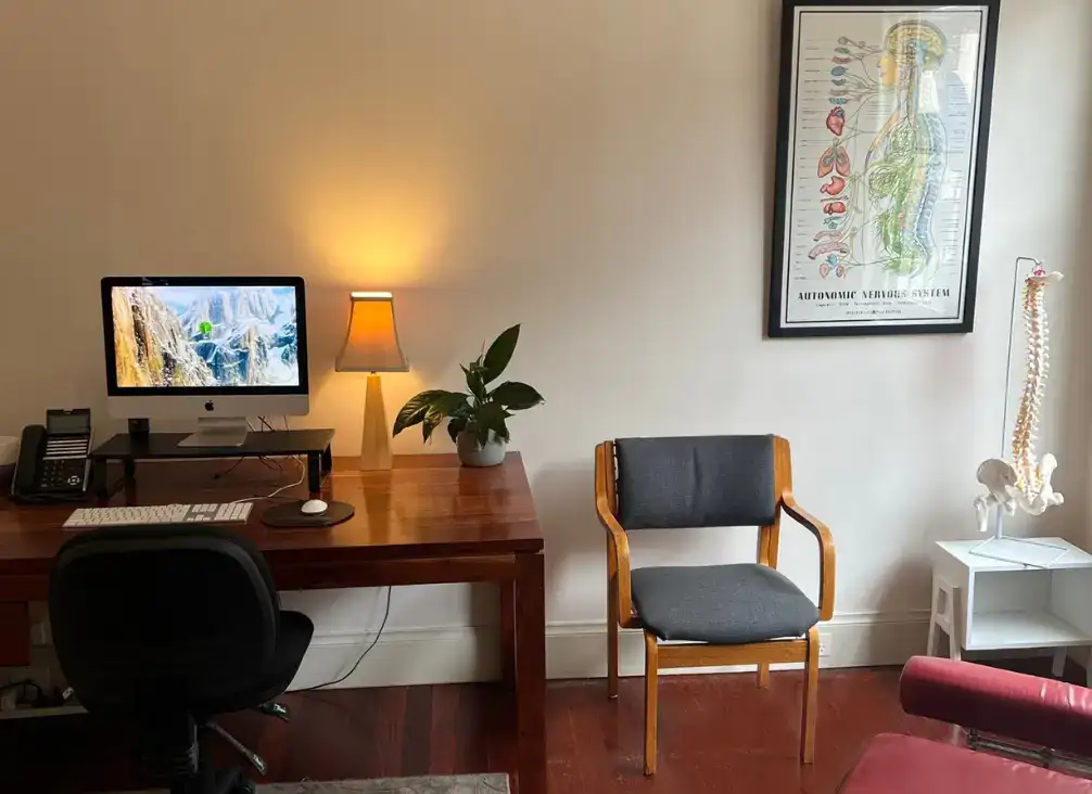 A treatment room set up with a podiatry chair and instruments