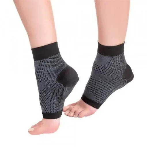 Two feet in black open-toe compression sleeves covering the heel, arch and ankle