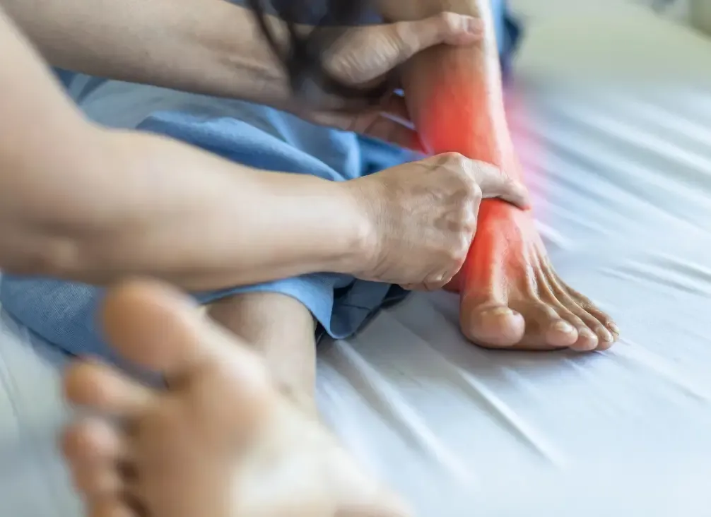 The inner ankle, where the posterior tibial nerve passes through the tarsal tunnel