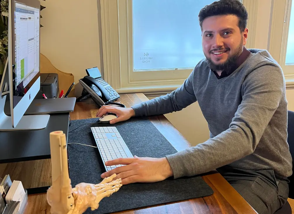 Brunswick podiatrist Dr Husein Al Zurifi at his clinic desk