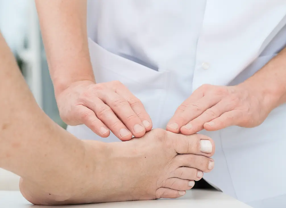 Podiatrist examining a bunion on a patient’s foot – podiatry Brunswick treatment for foot deformities.