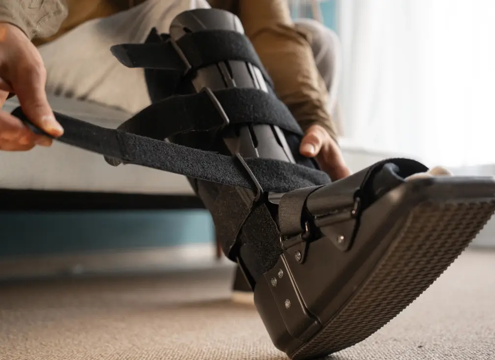 Applying a CAM moon boot for foot fracture recovery – podiatry Brunswick & Melbourne support.