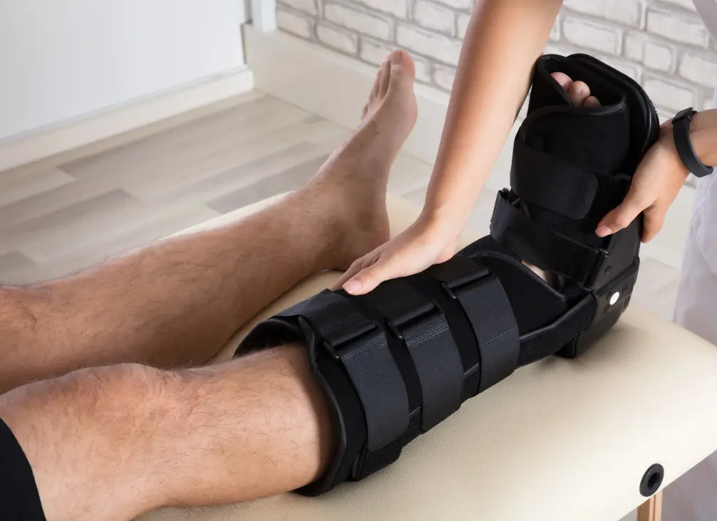 Podiatrist fitting a CAM walker boot – injury recovery support at podiatry Brunswick clinic.