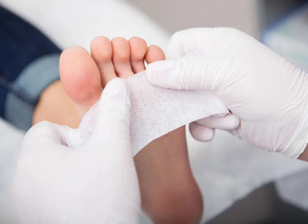 Podiatrist dressing a foot wound – diabetic foot ulcer care in podiatry Brunswick clinic.