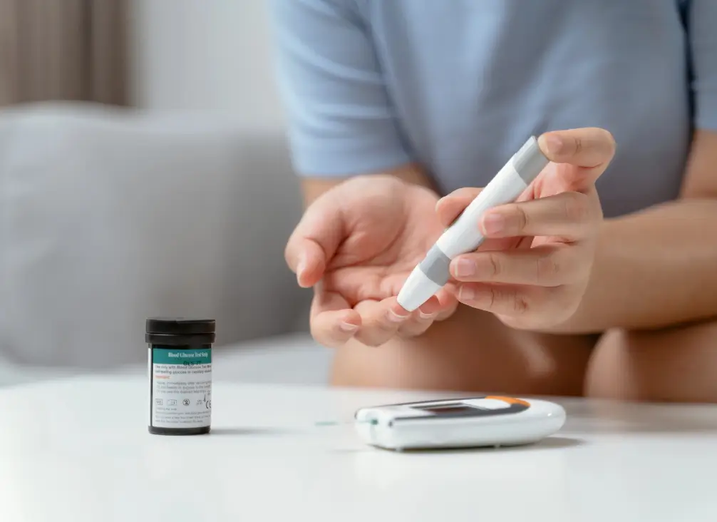 Person checking blood sugar with glucose monitor – diabetic podiatry care in Brunswick.