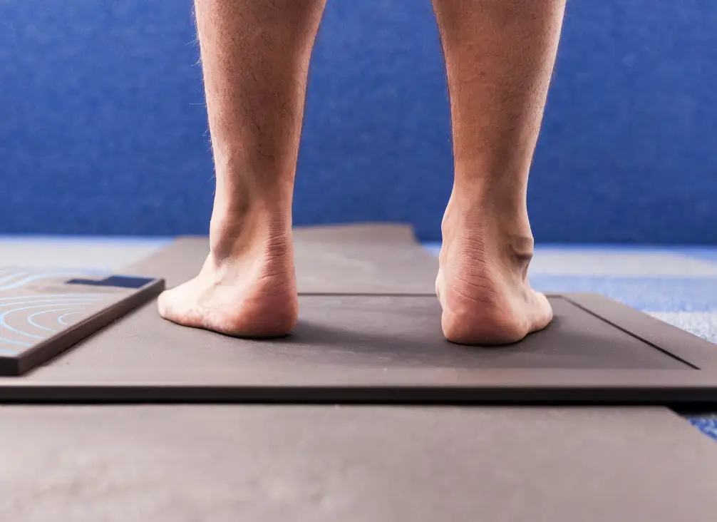 Foot biomechanics assessment using a pressure plate at a podiatry clinic.