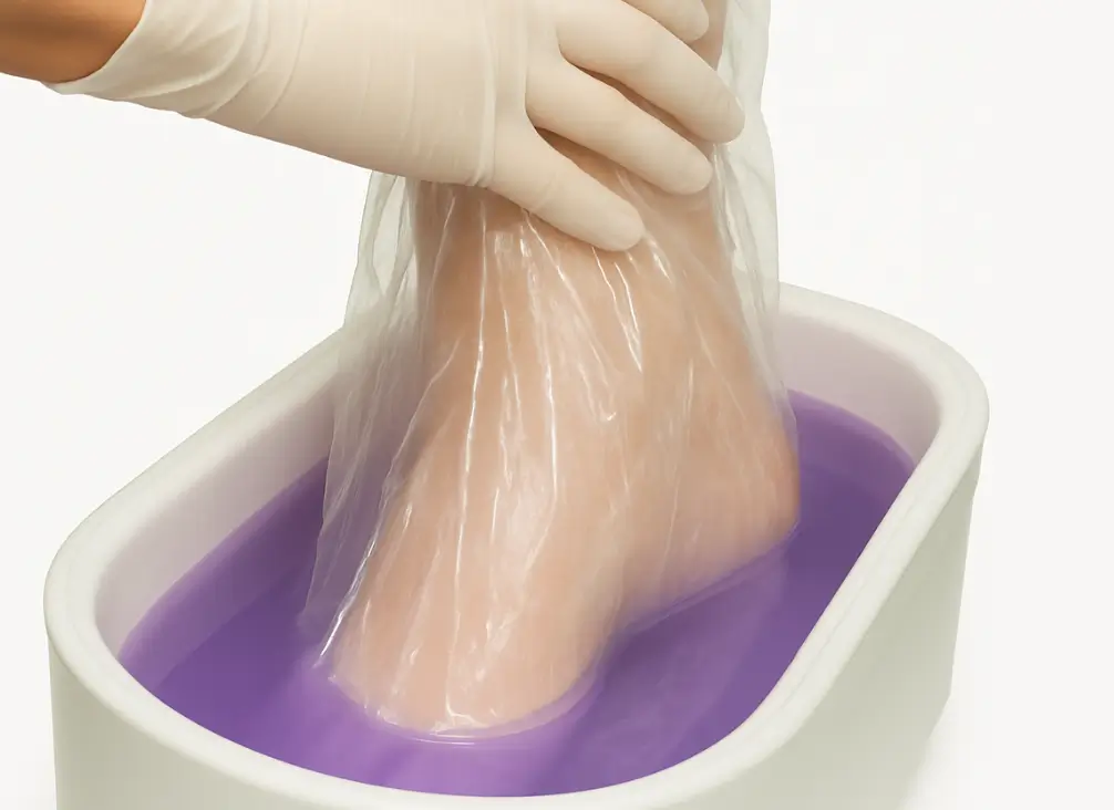 Foot in paraffin wax bath with glove – podiatry Brunswick therapy for circulation and chilblains.