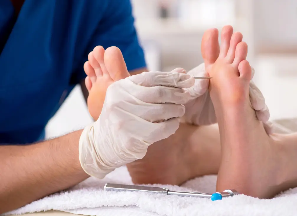Podiatrist testing foot sensation with needle – diabetic neuropathy care in Brunswick podiatry clinic.