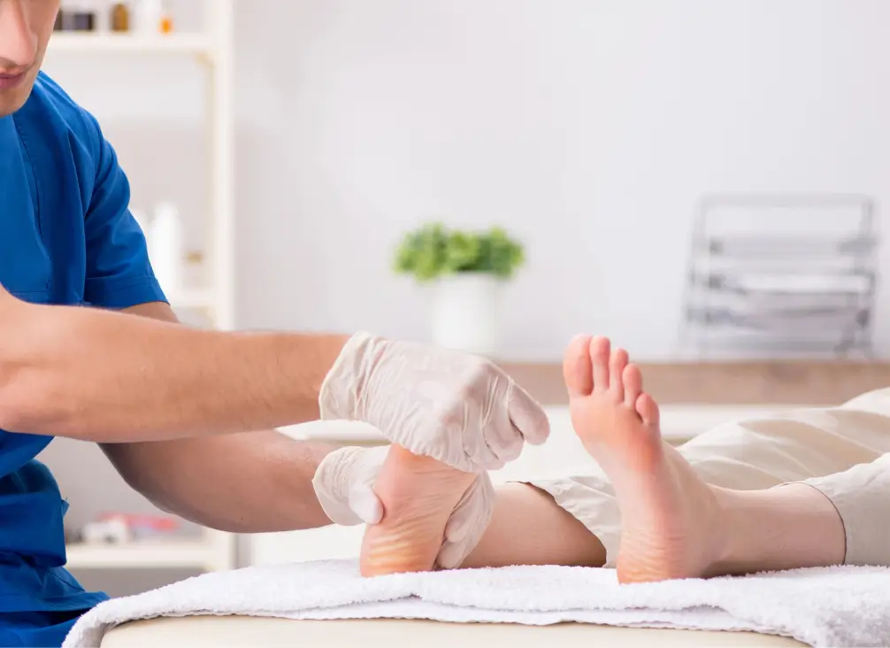 Podiatrist wearing gloves examining patient’s feet – podiatry Brunswick clinic consultation.