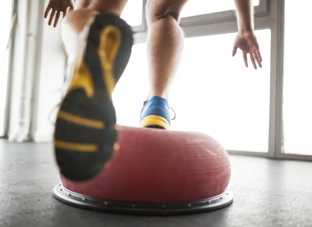 Man balancing on exercise pod for foot rehabilitation – podiatry exercises Brunswick