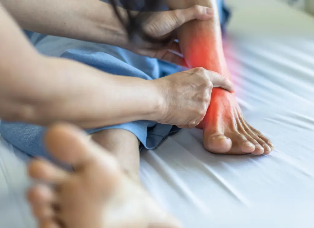 Podiatrist examining inflamed ankle and foot – possible Tarsal Tunnel Syndrome treatment in Brunswick.