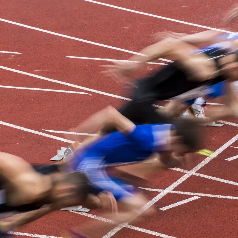 Sprinters taking off from starting blocks with risk of podiatry-related injuries