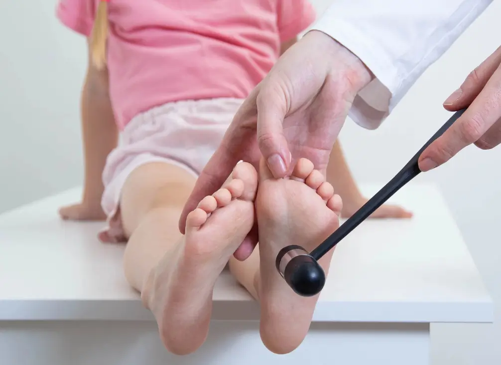 Paediatric podiatrist assessing foot reflexes during a child’s podiatry appointment in Brunswick or Melbourne.