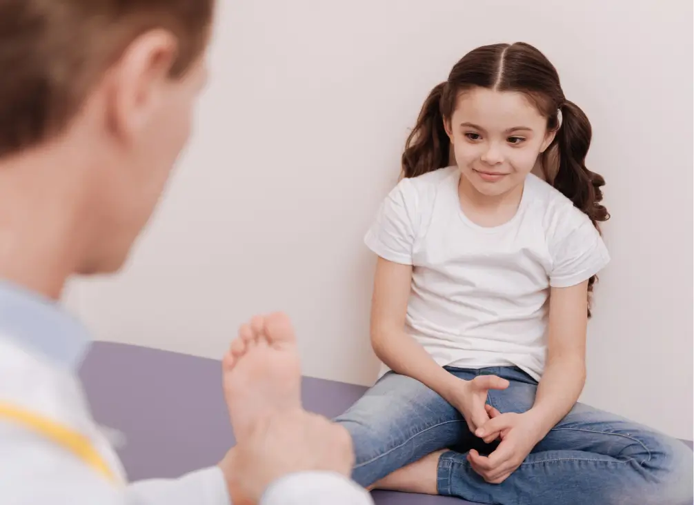 Podiatrist examining young girl's foot for Sever’s Disease in Melbourne