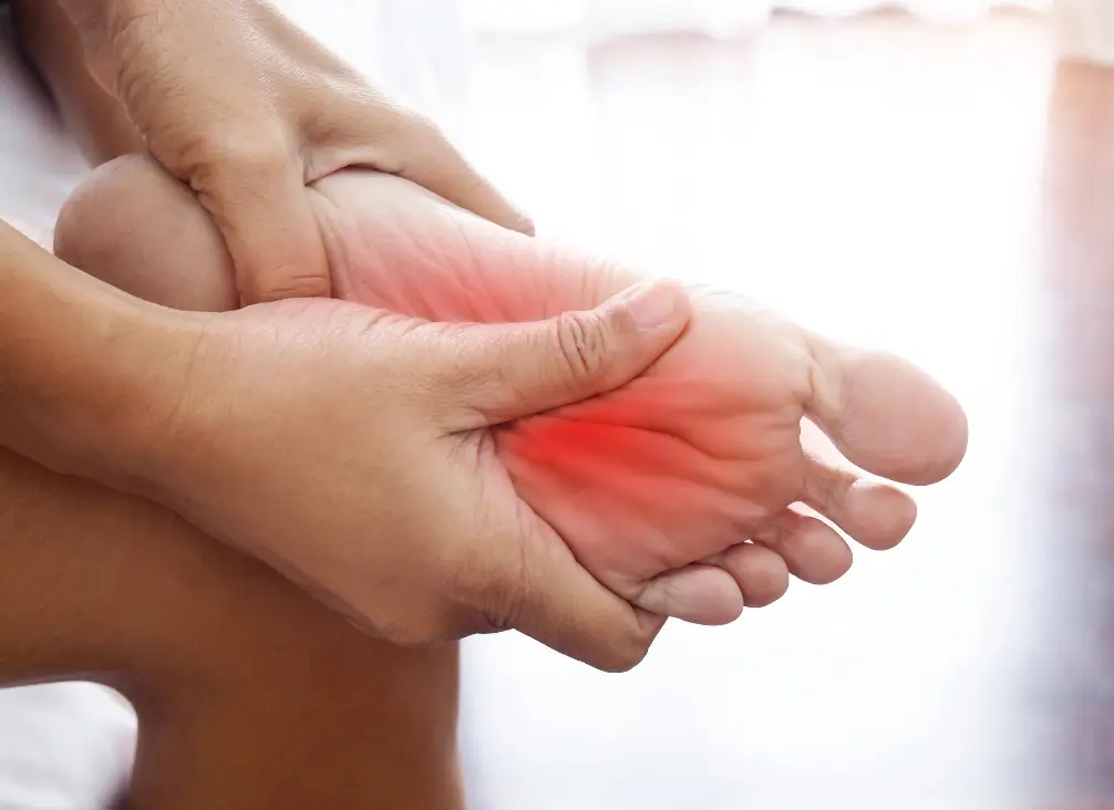 Person massaging foot to relieve pain from Morton’s neuroma
